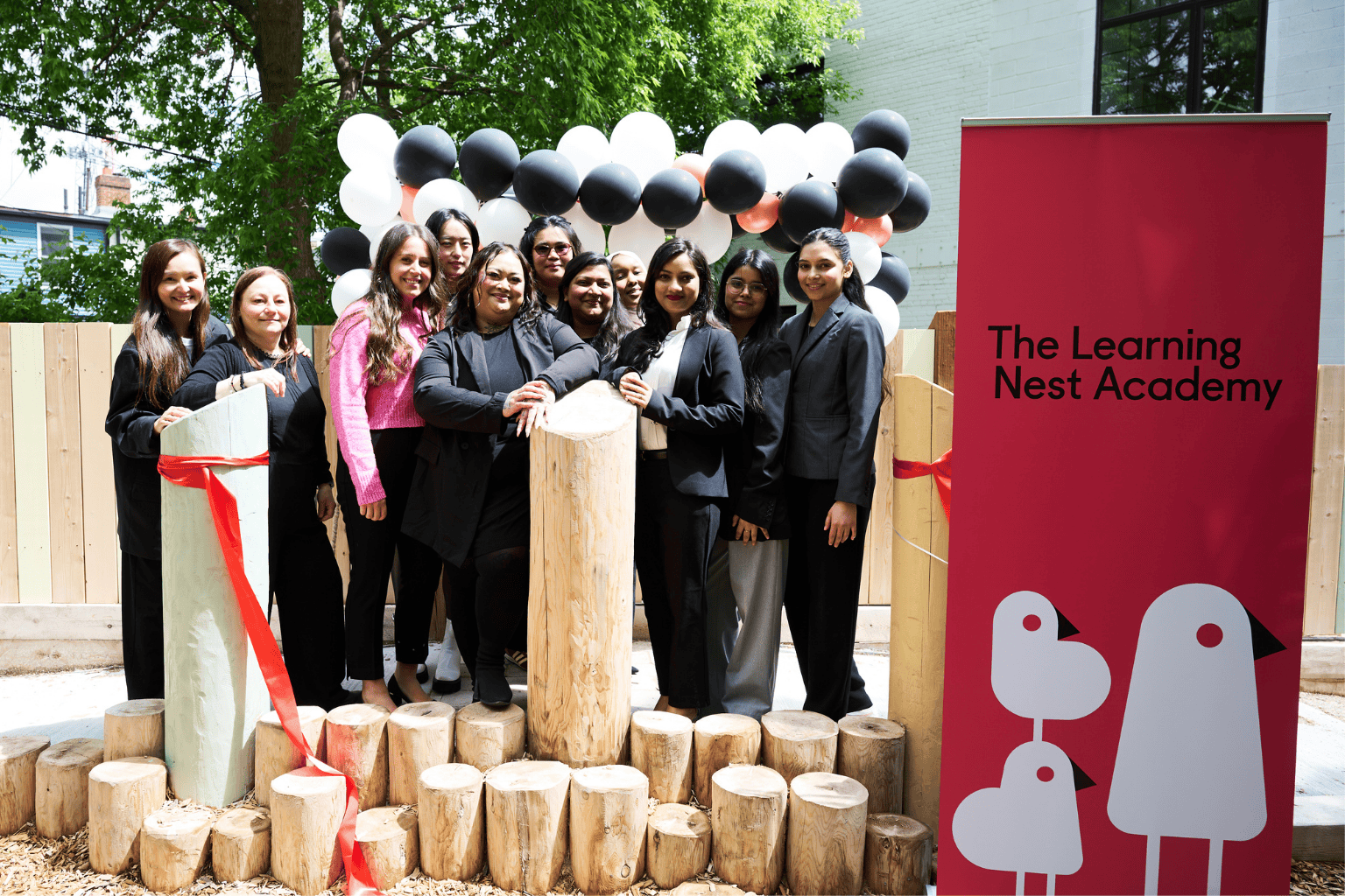 A group of smiling team members gathered together on the playground