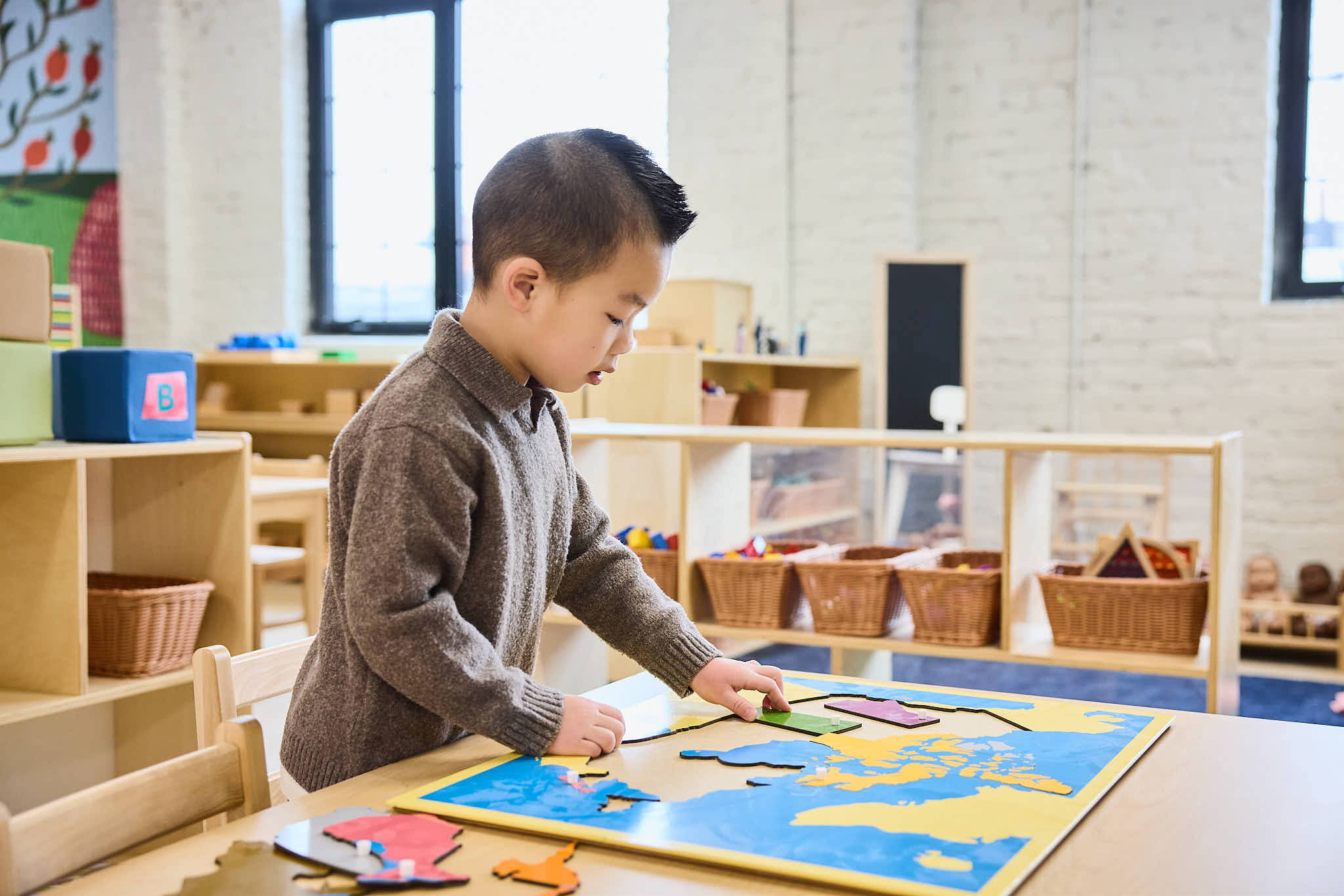 Preschool child doing a map puzzle