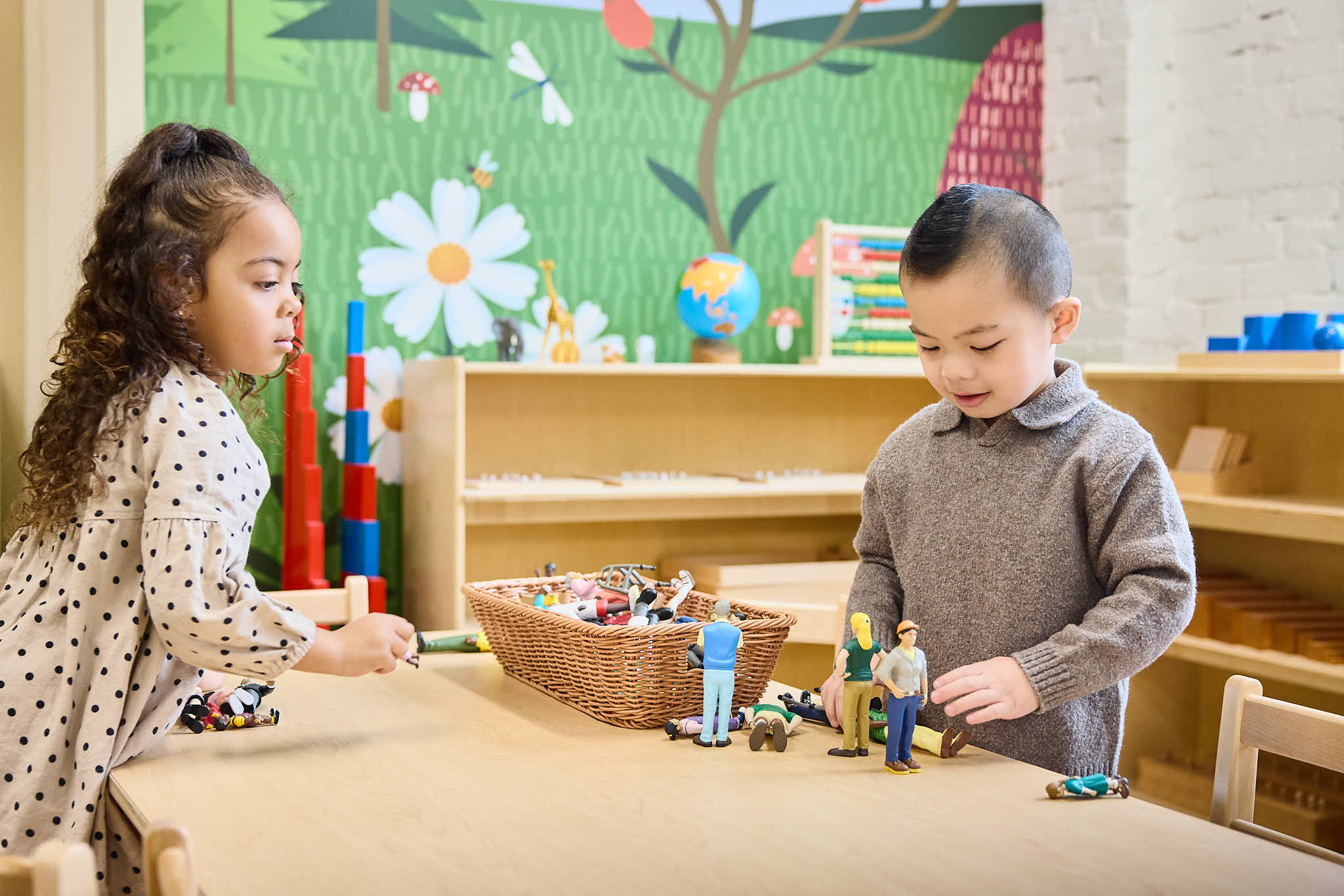 Two Preschoolers interacting with loose part, open ended materials