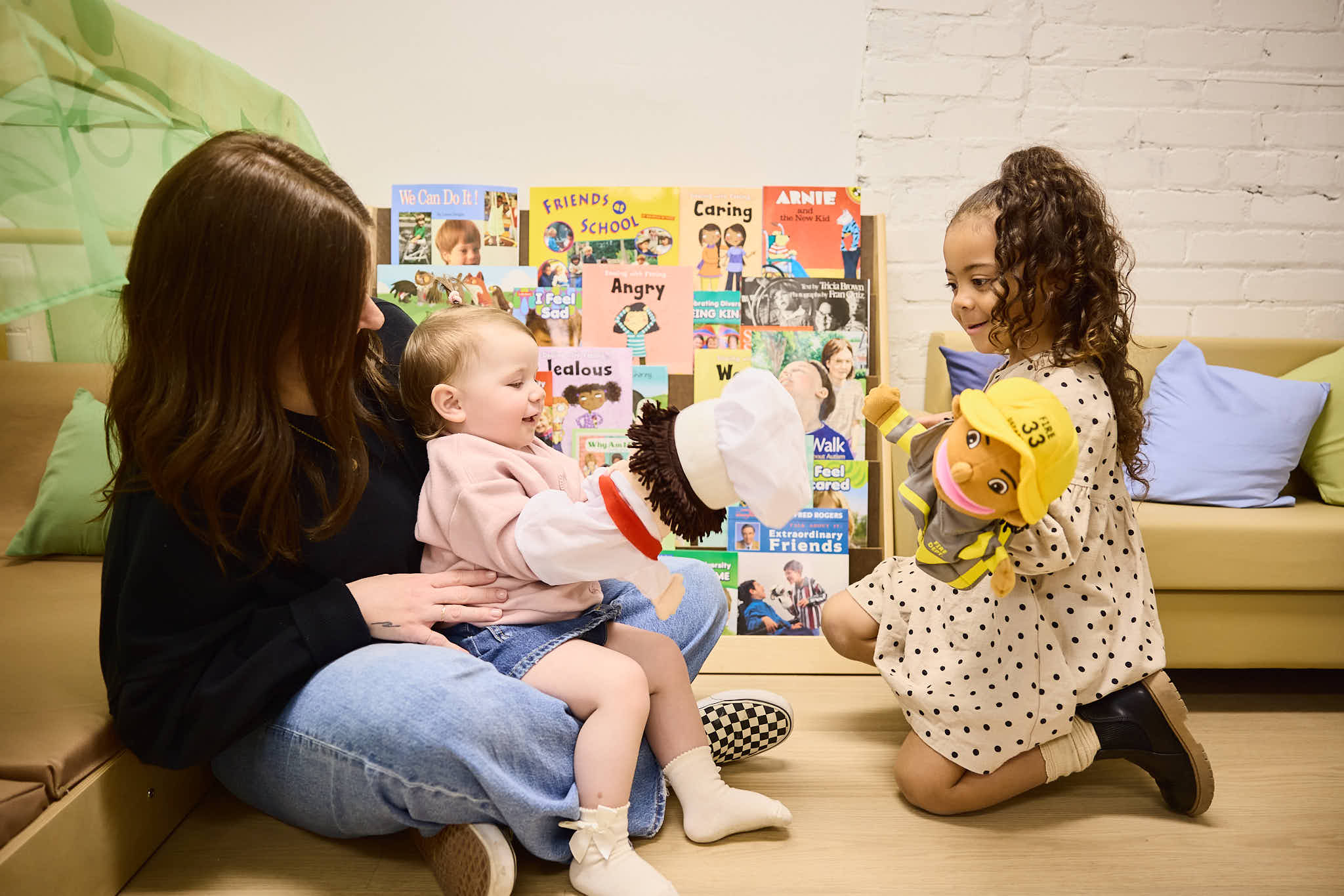 Educator with two children, using Second Step puppets