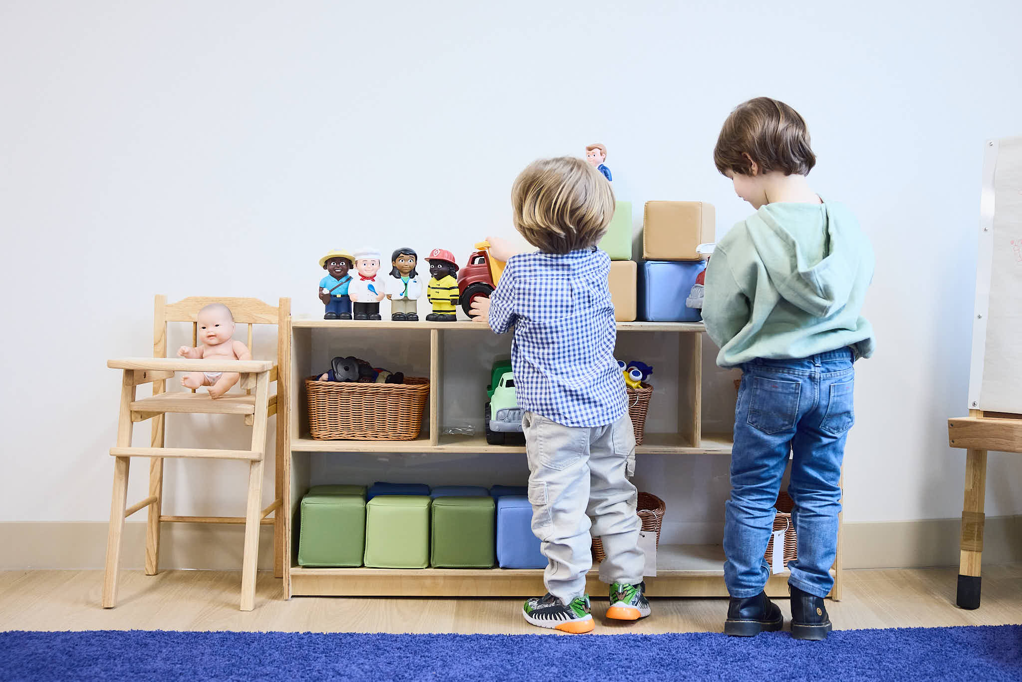 Brothers looking at Core Knowledge shelf together